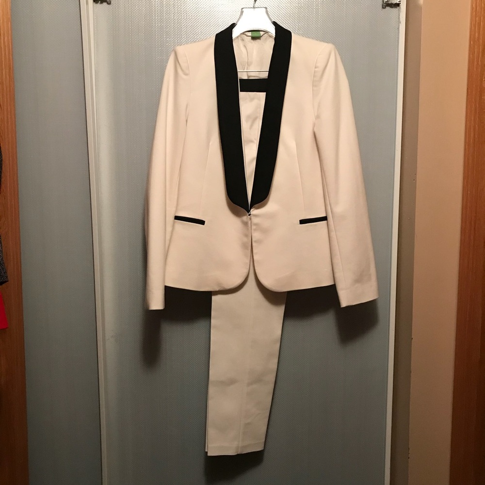 Elegant cream suit with black trim.